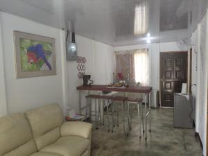 a living room with a couch and a table at Inmoexito Eco Tours in Upala