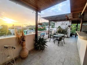 a balcony of a house with a table and chairs at Hotel Taganga Plaza Santa Marta in Taganga