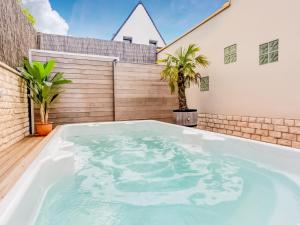 a hot tub in the backyard of a house at Peaceful Getaway with Spa in Avelgem