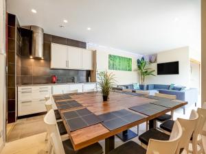 a kitchen and dining room with a table and chairs at Peaceful Getaway with Spa in Avelgem