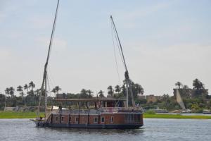 a boat on the water with people on it at Cinderella dahabya in Luxor