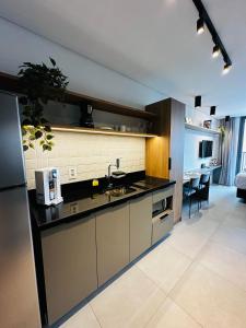 a kitchen with a sink and a counter top at Almagah 227 - Studios de Alto Padrão no Tatuapé - SP in São Paulo