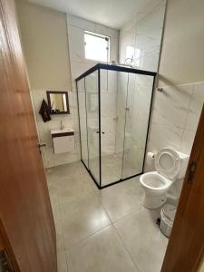 a bathroom with a glass shower and a toilet at Casa, Delfinópolis - Serra da Canastra, MG in Delfinópolis +24 photos