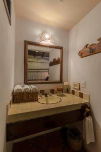 a bathroom with a sink and a mirror at Casa Huitsiki in Cuetzalán del Progreso
