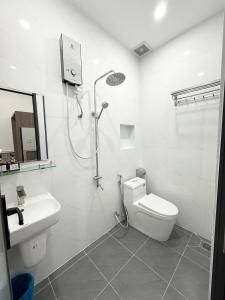 a bathroom with a shower and a toilet and a sink at Motel Nam Nguyên in Buôn Kô Sir