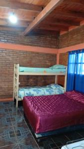 a bedroom with two bunk beds in a room at Cabañas Arelí in Santa María