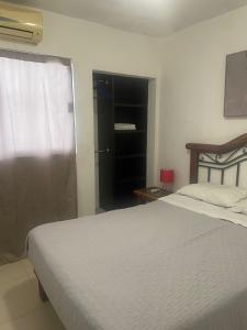 a bedroom with a large bed and a window at Casa Perfectamente Ubicada in Tampico +9 photos