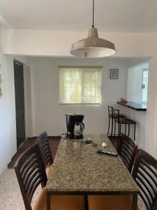 a kitchen with a table with chairs and a counter top at Casa Perfectamente Ubicada in Tampico