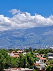 a view of a city with mountains in the background at Lily's Apartamentos in Cochabamba