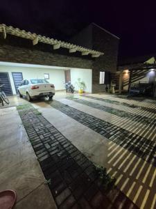 a white car parked in a garage at night at Casa 4 quartos com piscina em Aparecida de Goiania in Aparecida de Goiânia