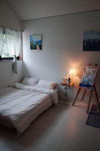 a bedroom with a bed and a table and a painting at 연봉리 스테이 in Hongcheon