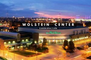 a building with a sign that reads woltten center at night at Central Downtown Loft | Parking•Gym•Security in Cleveland