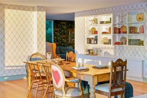 a dining room with a wooden table and chairs at The Veranda - Panoramic Bay Views Private Beach Access Pool in Mount Eliza