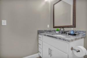 a bathroom with a sink and a mirror at Central Downtown Loft | Parking•Gym•Security in Cleveland +19 photos