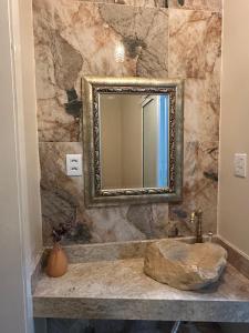 a bathroom with a sink and a mirror at Casas Temáticas in Tramandaí +30 photos