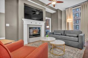 a living room with a couch and a fireplace at Central Downtown Loft | Parking•Gym•Security in Cleveland
