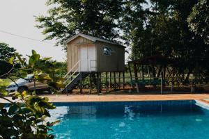 eine kleine Hütte neben einem Schwimmbecken in der Unterkunft Pousada MAKS in Ribeirão Preto