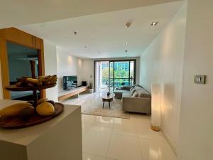 a living room with a couch and a table at Fancy Beachfront Condominium in North Pattaya