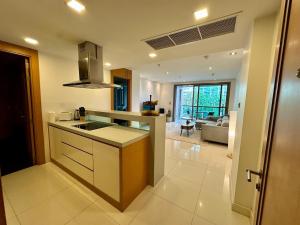 a kitchen with a sink and a stove top oven at Fancy Beachfront Condominium in North Pattaya