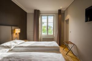 Postel nebo postele na pokoji v ubytování Hôtel du Théâtre, Boutique Hôtel