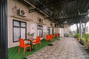 a row of orange chairs and tables in a building at Serenity Busay Room 6 in Cebu City