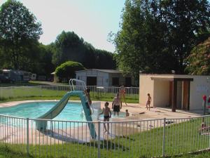 a group of children playing in a swimming pool at Chalet 4 pers avec Terrasse à Capvern - API-1-52-1745 in Capvern