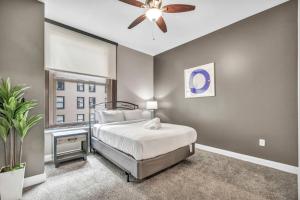 a bedroom with a bed and a ceiling fan at Upscale Downtown Loft | Parking • Gym in Cleveland