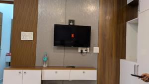 a room with a flat screen tv on a wall at Mountain Mist Ranipuram in Kallar