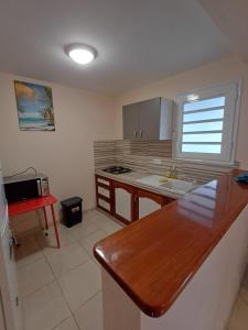 a kitchen with a sink and a counter top at Santa Marta in Rivière-Pilote