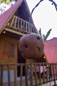 a ball hanging from a street light in front of a house at Cabana Suiça 2 in Guaramiranga +4 photos
