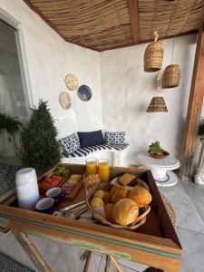 a tray of bread and drinks on a table at Pousada Villa Grega de Piri in Pirenópolis