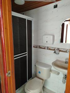 a small bathroom with a toilet and a sink at Aventura inn 304 in Rodadero