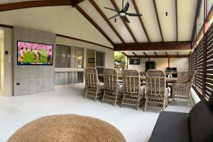a living room with chairs and a television on a wall at Cowan Lodge in Cowan Cowan