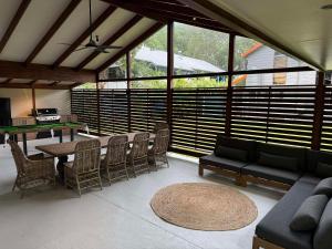 a living room with a table and chairs at Cowan Lodge in Cowan Cowan