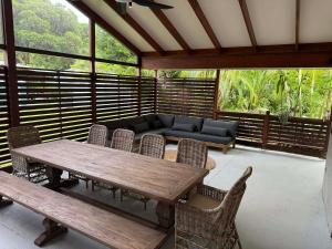 a screened in porch with a wooden table and chairs at Cowan Lodge in Cowan Cowan +20 photos