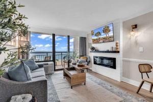 a living room with a couch and a fireplace at Last Chance Summer, Oceanfront Pools and Beach in Myrtle Beach