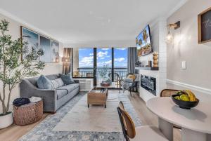 a living room with a couch and a table at Last Chance Summer, Oceanfront Pools and Beach in Myrtle Beach