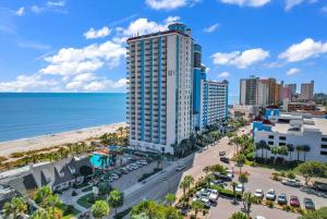 a view of the beach and a tall building at Last Chance Summer, Oceanfront Pools and Beach in Myrtle Beach