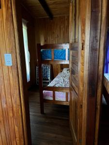 a small room with a bunk bed in a cabin at Cabañas El Macuco in Dos de Mayo +5 photos