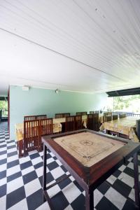 a room with a ping pong table on a checkered floor at Snow Drops Resort in Vythiri +78 photos