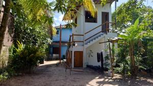 a house with a staircase leading up to it at Suíte Colibri - Centro de Barra Grande in Marau +7 photos