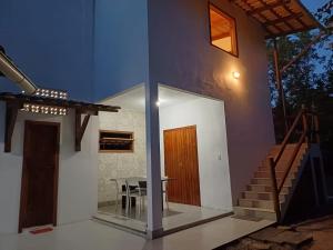 a small house with a table and a staircase at Suíte Colibri - Centro de Barra Grande in Marau