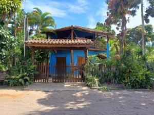 a blue house with a fence in front of it at Suíte Colibri - Centro de Barra Grande in Marau