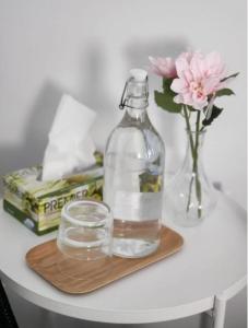 a bottle of water sitting on a table with a glass at Twinbeach Sanctuary in Mersing