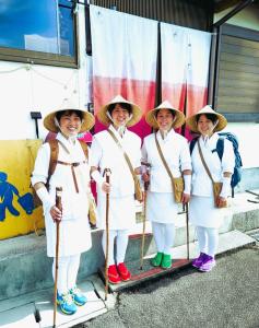 a group of women dressed in white posing for a picture at Super Henro Inn in Nahari