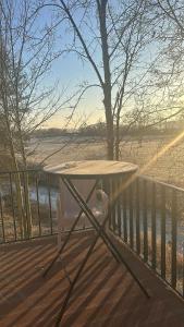 a picnic table on a deck with a fence at Auszeit am Ipf in Bopfingen