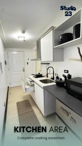 a kitchen with a sink and a counter top at Studio B23 Azure North in San Fernando