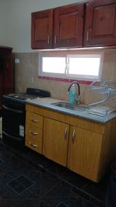 a kitchen with a sink and a stove at Cabañas Arelí in Santa María