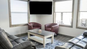 a living room with couches and a table and chairs at Elk Horn Cabin Rental in Valemount