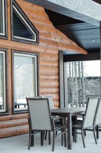 a table and chairs in front of a log cabin at Elk Horn Cabin Rental in Valemount